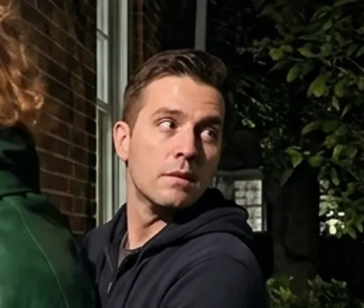 Close-up still of Ben glancing back over his shoulder
